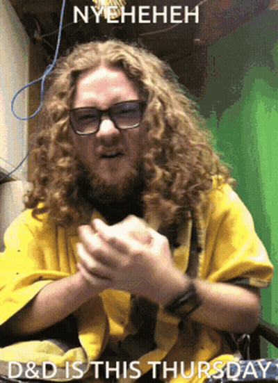 A Man With Long Curly Hair Is Wearing Glasses And A Yellow Shirt GIF