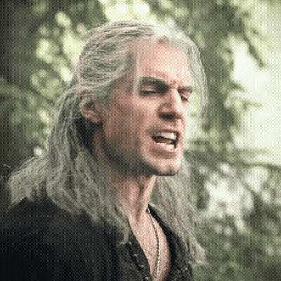A Man With Long Gray Hair Making A Funny Face GIF