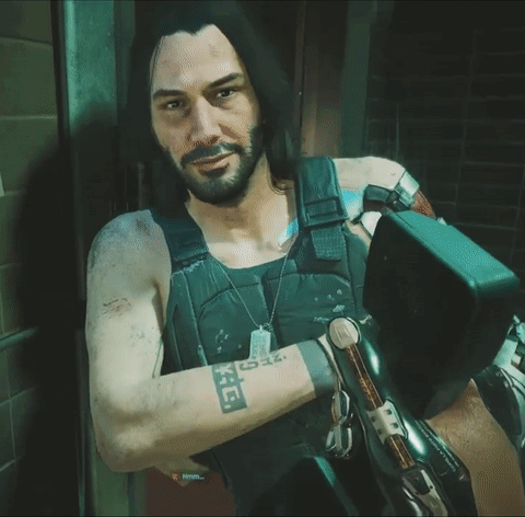 A Man With Long Hair And A Beard Has A Tattoo On His Arm That Says ' X ' GIF