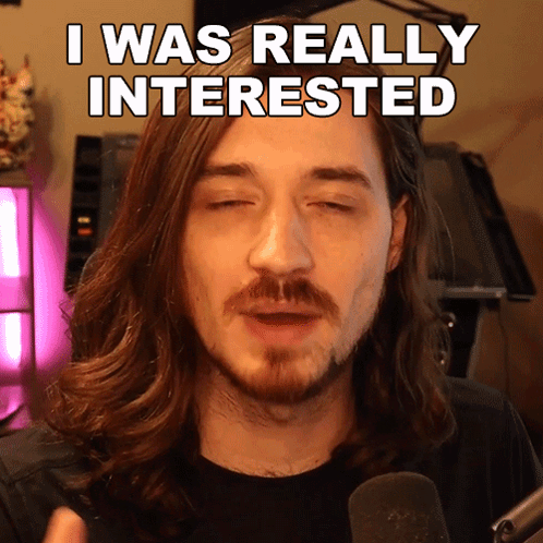 A Man With Long Hair And A Beard Has His Eyes Closed And Says I Was Really Interested GIF