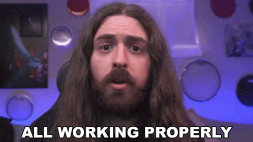 A Man With Long Hair And A Beard Has The Words All Working Properly Above His Head GIF