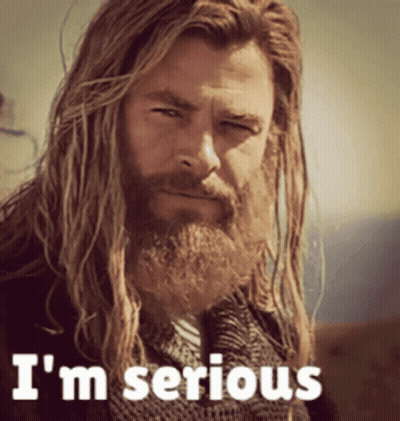 A Man With Long Hair And A Beard Has The Words I 'M Serious On His Face GIF