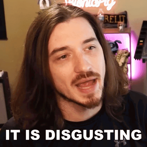 A Man With Long Hair And A Beard Has The Words It Is Disgusting Above His Head GIF