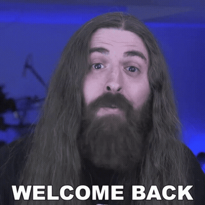 A Man With Long Hair And A Beard Has The Words Welcome Back On His Face GIF