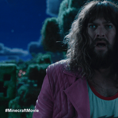A Man With Long Hair And A Beard In A Pink Jacket GIF