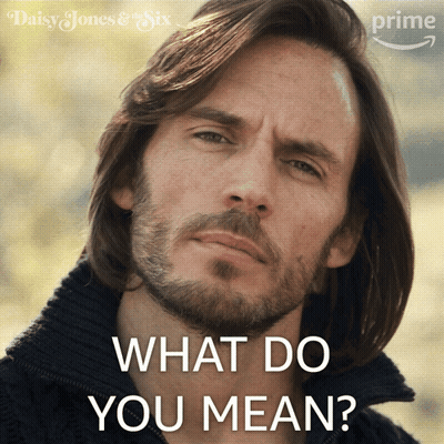 A Man With Long Hair And A Beard Is Asking " What Do You Mean " GIF