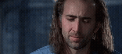 A Man With Long Hair And A Beard Is Crying In A Room . GIF