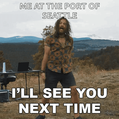 A Man With Long Hair And A Beard Is Dancing In A Field With Mountains In The Background GIF