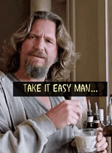 A Man With Long Hair And A Beard Is Holding A Cup Of Coffee And A Bottle Of Beer . GIF