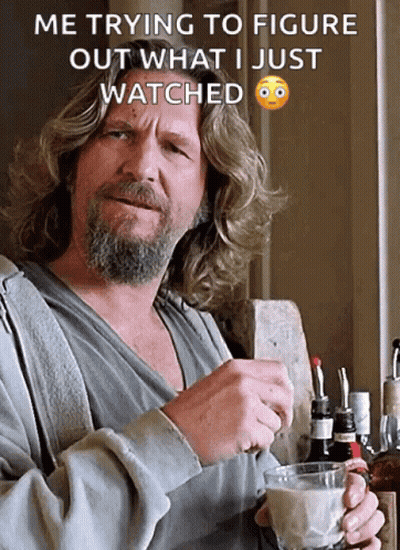 A Man With Long Hair And A Beard Is Holding A Cup Of Coffee And A Bottle Of Whiskey In His Hand GIF