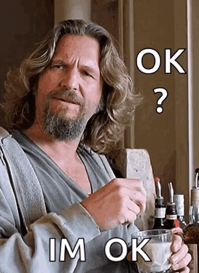 A Man With Long Hair And A Beard Is Holding A Glass With The Words Ok Im Ok Above Him GIF
