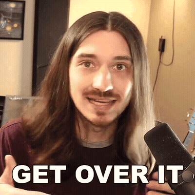A Man With Long Hair And A Beard Is Holding A Microphone And Says Get Over It GIF