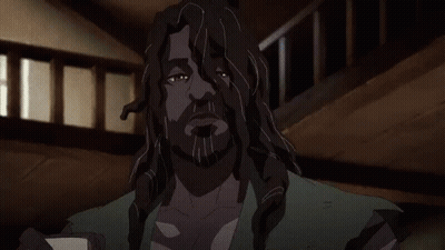 A Man With Long Hair And A Beard Is Holding A Piece Of Paper In His Hands . GIF