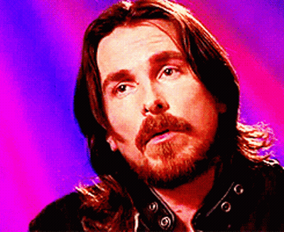 A Man With Long Hair And A Beard Is Looking Up GIF