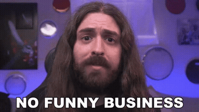 A Man With Long Hair And A Beard Is Making A Funny Face And Saying No Funny Business . GIF