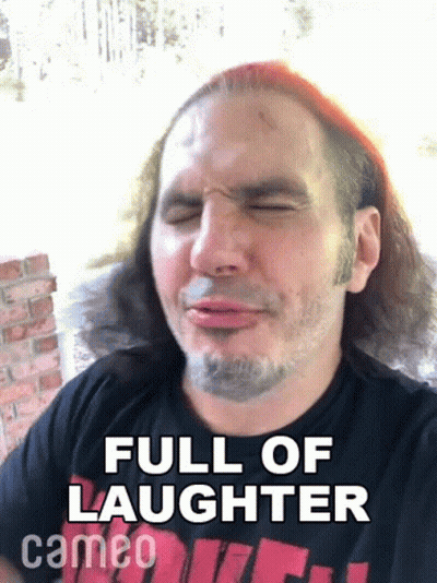 A Man With Long Hair And A Beard Is Making A Funny Face And Says Full Of Laughter Cameo On The Bottom . GIF