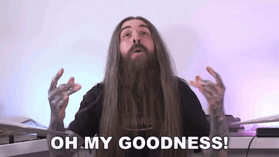 a man with long hair and a beard is making a funny face and says `` oh my goodness '' .