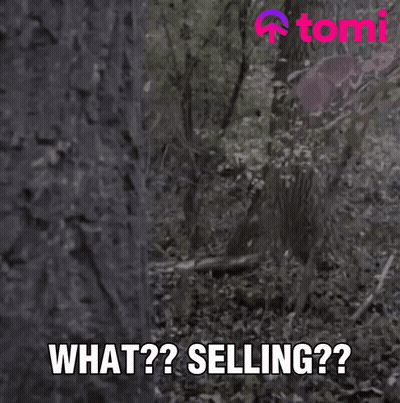A Man With Long Hair And A Beard Is Peeking Out From Behind A Tree And Says What Selling GIF