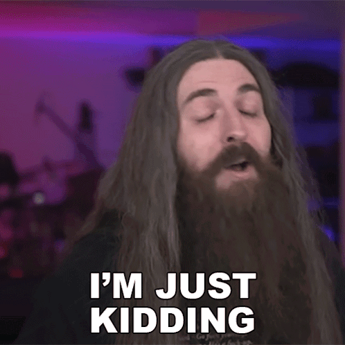 A Man With Long Hair And A Beard Is Saying I 'M Just Kidding . GIF