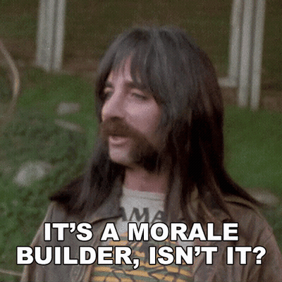 A Man With Long Hair And A Beard Is Saying It 'S A Morale Builder Isn 'T It GIF