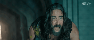 A Man With Long Hair And A Beard Is Screaming In Front Of An Apple Tv+ Sign GIF