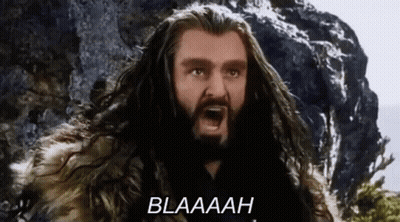 A Man With Long Hair And A Beard Is Screaming With The Word Blaaah Written Below Him . GIF