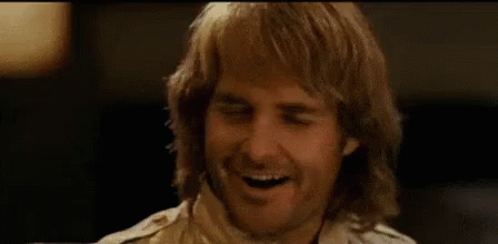 A Man With Long Hair And A Beard Is Smiling And Says `` Shut Your Butt '' . GIF