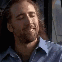 A Man With Long Hair And A Beard Is Smiling With His Eyes Closed While Sitting On A Bus . GIF