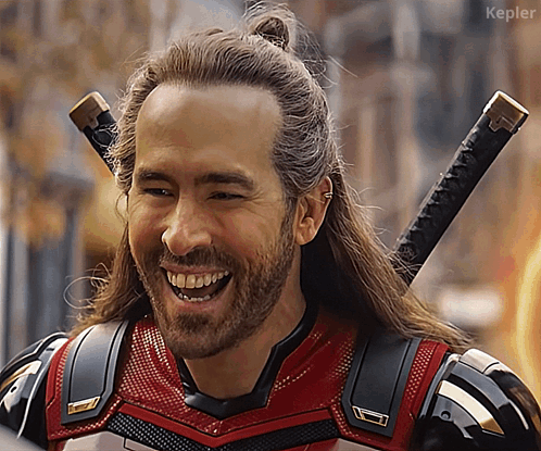 A Man With Long Hair And A Beard Is Smiling With Kepler In The Lower Right Corner GIF