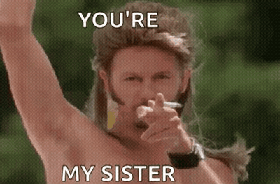 A Man With Long Hair And A Beard Is Smoking A Cigarette And Pointing . GIF