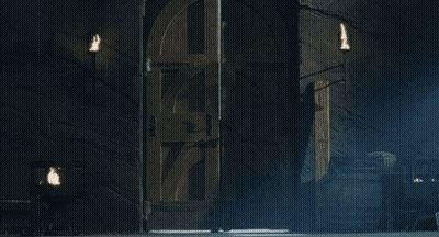 A Man With Long Hair And A Beard Is Standing In A Dark Room With His Arms Outstretched GIF