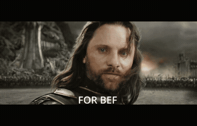 A Man With Long Hair And A Beard Is Standing In A Field With The Words For Bef Written Below Him GIF