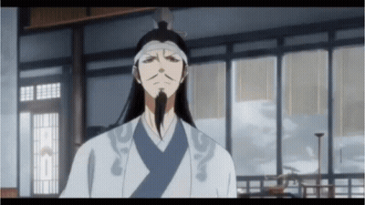 A Man With Long Hair And A Beard Is Standing In A Room With A Lot Of Windows GIF