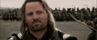 A Man With Long Hair And A Beard Is Standing In Front Of A Crowd Of Soldiers GIF