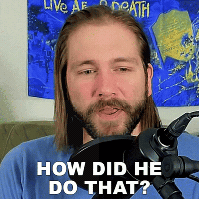A Man With Long Hair And A Beard Is Standing In Front Of A Microphone Asking How Did He Do That GIF