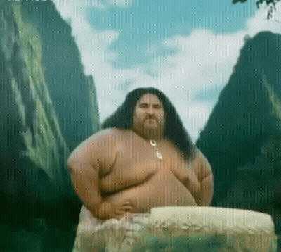 A Man With Long Hair And A Beard Is Standing In Front Of A Mountain .. GIF