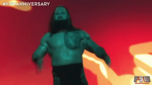 A Man With Long Hair And A Beard Is Standing In Front Of A Red And Yellow Background . GIF
