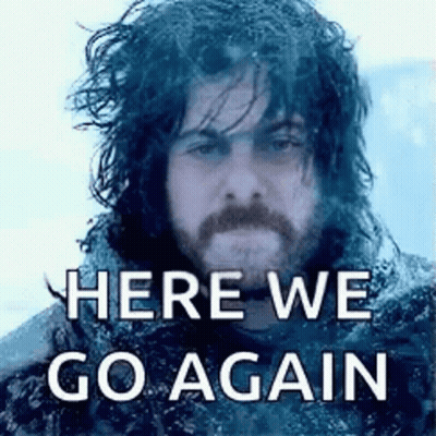 A Man With Long Hair And A Beard Is Standing In The Snow With The Words `` Here We Go Again '' Written Above Him . GIF
