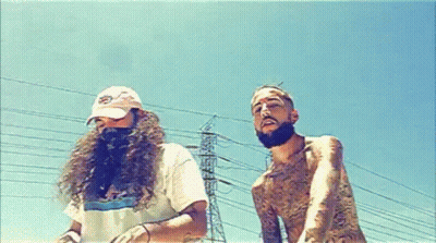 A Man With Long Hair And A Beard Is Standing Next To Another Man With A Beard GIF