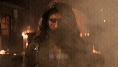A Man With Long Hair And A Beard Is Surrounded By Smoke And Aura GIF