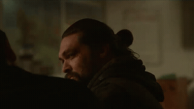 A Man With Long Hair And A Beard Is Talking To Another Man . GIF