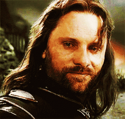 A Man With Long Hair And A Beard Is Wearing A Black Jacket GIF