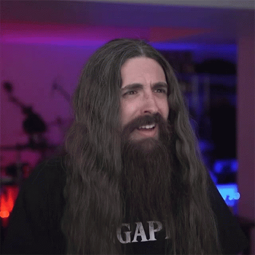 A Man With Long Hair And A Beard Is Wearing A Gap T-Shirt GIF