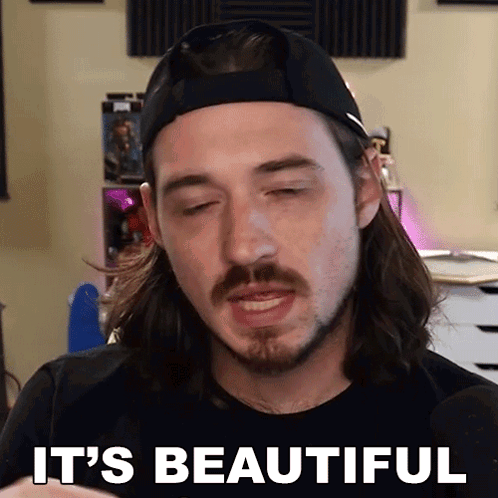 Man With Long Hair And Beard Wearing Hat Says It's Beautiful GIF