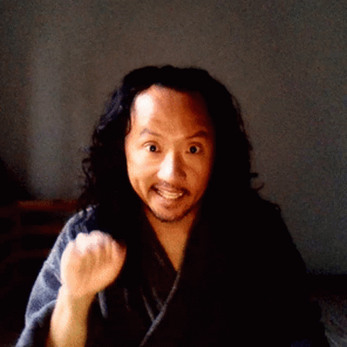 A Man With Long Hair And A Beard Is Wearing A Robe GIF
