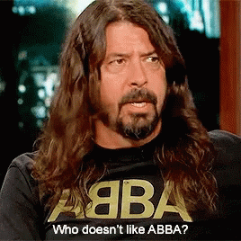 A Man With Long Hair And A Beard Is Wearing A Shirt That Says Abba GIF