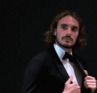 A Man With Long Hair And A Beard Is Wearing A Suit And Bow Tie GIF