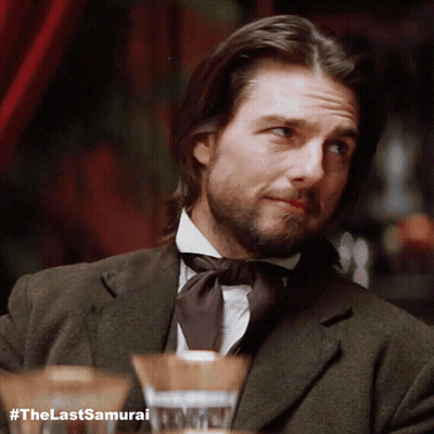 A Man With Long Hair And A Beard Is Wearing A Suit And Tie GIF