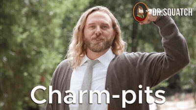 A Man With Long Hair And A Beard Is Wearing A Sweater And Tie With The Words Charm-Pits On The Bottom GIF