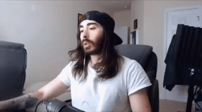 A Man With Long Hair And A Beard Is Wearing A White Shirt And A Black Hat GIF